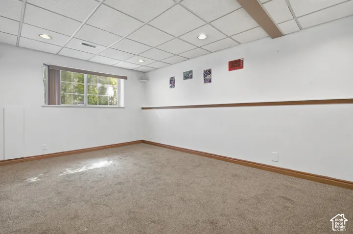 Recessed lighting, drop ceiling, wood-finish trim, and a horizontal window
