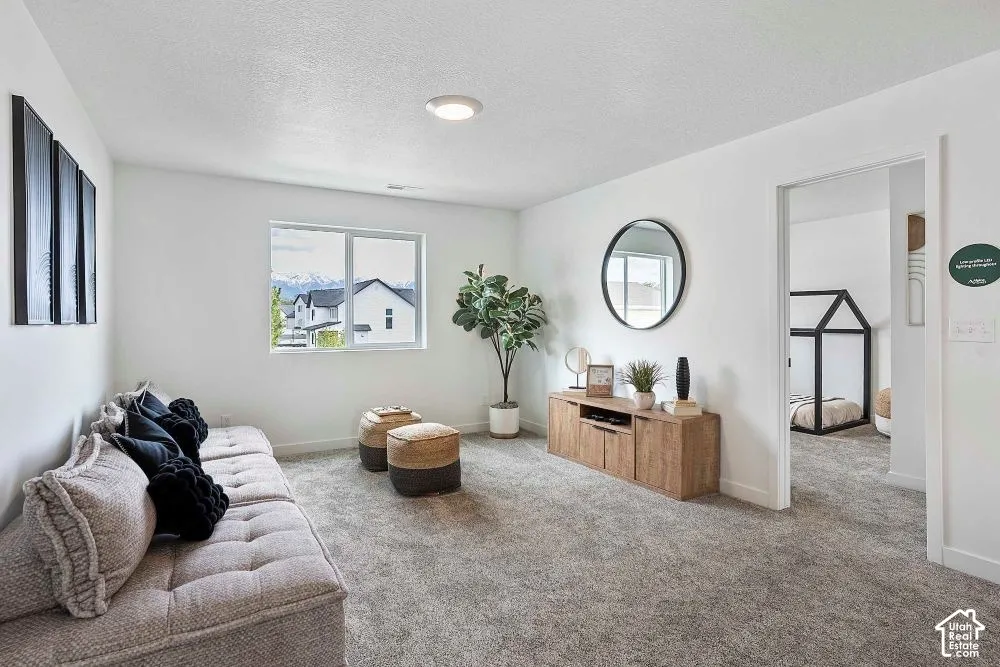 Carpeted room with a rectangular window, recessed lighting, and a wood-finish media console