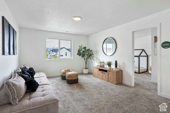 Carpeted room with a rectangular window, recessed lighting, and a wood-finish media console
