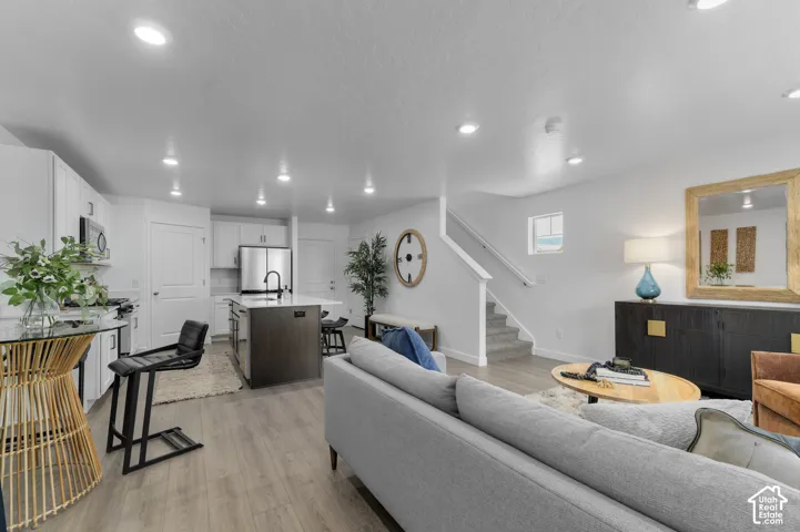 Open-concept living space featuring wood-finish flooring