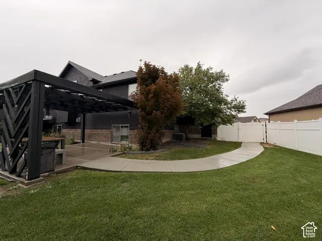 Expansive grassy yard with a concrete pathway