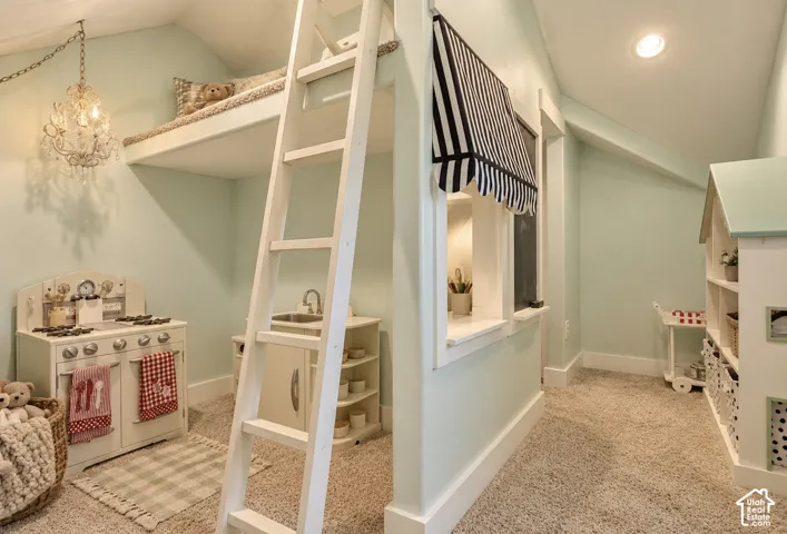 Carpeted room featuring a built-in loft bed with ladder access, recessed lighting, and a chandelier fixture
