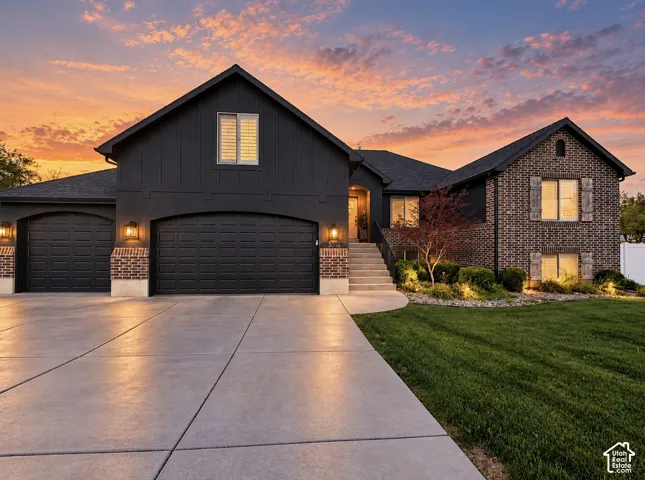 Brick and siding exterior with a multi-car garage
