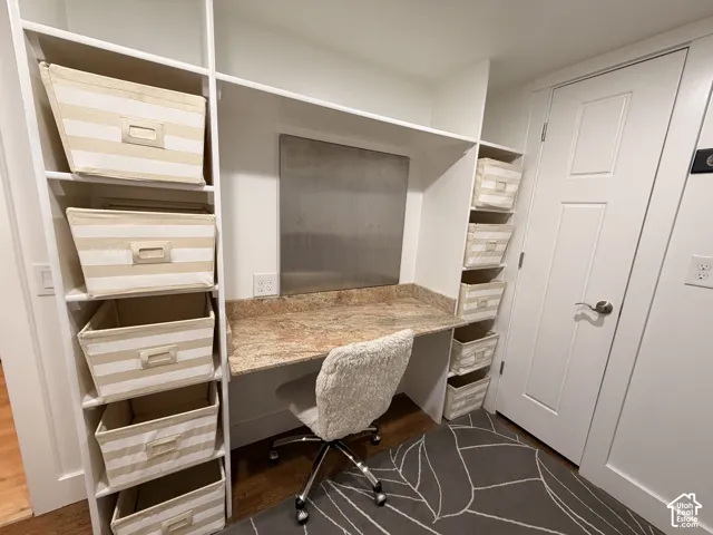 Built-in desk area featuring a stone-finish countertop