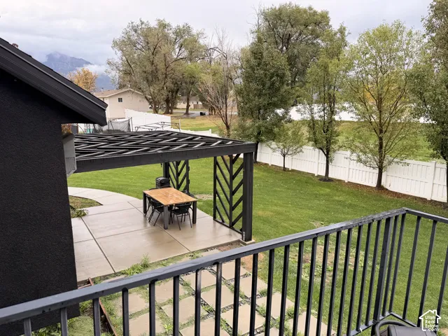 Expansive green lawn with a white privacy fence