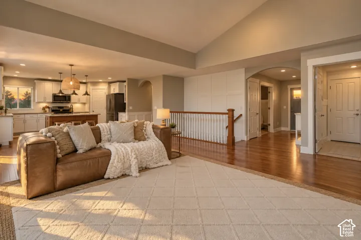 Open-concept layout with hardwood flooring
