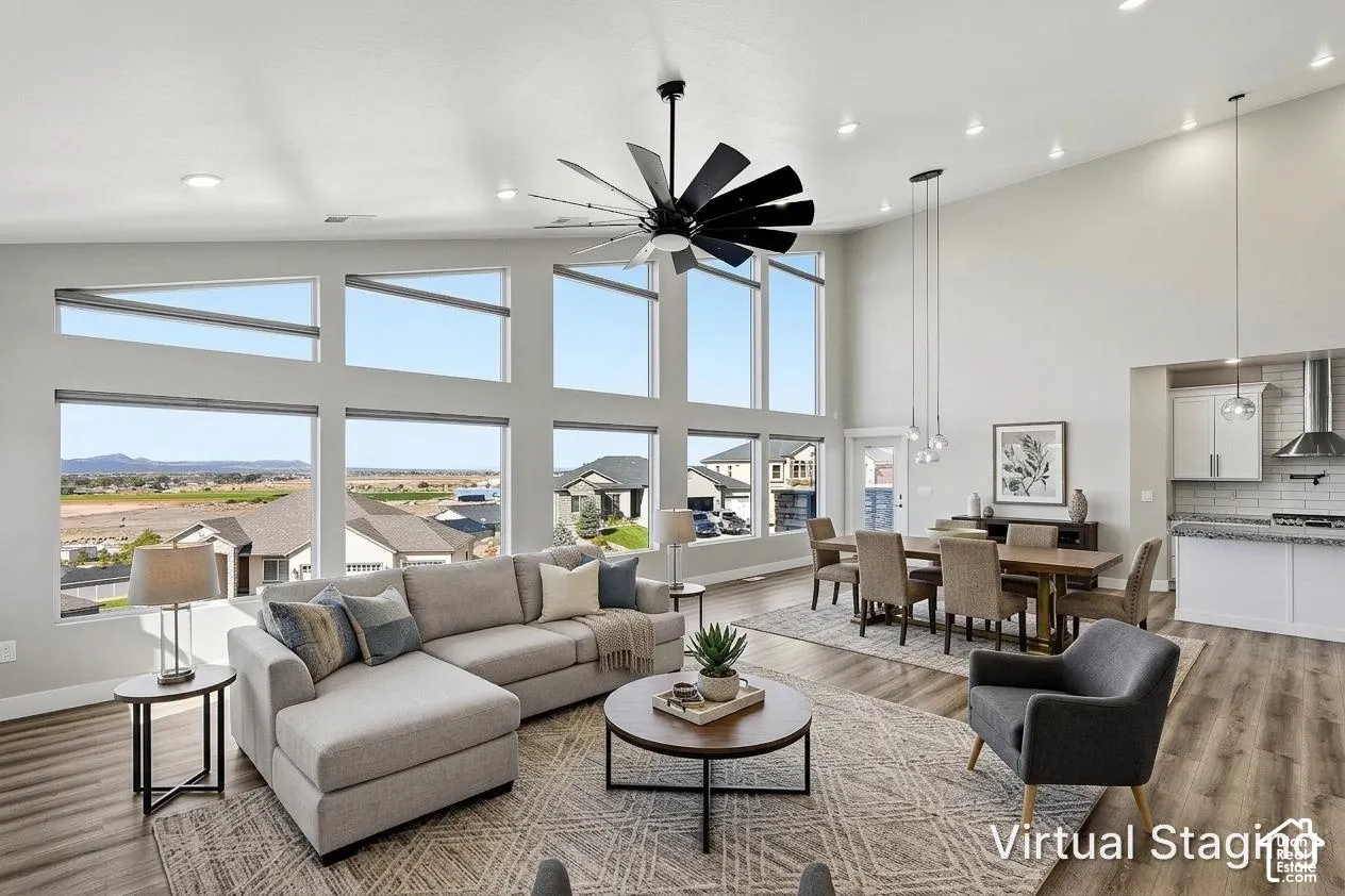 Great room featuring high ceilings, extensive window array, and wood-finish flooring