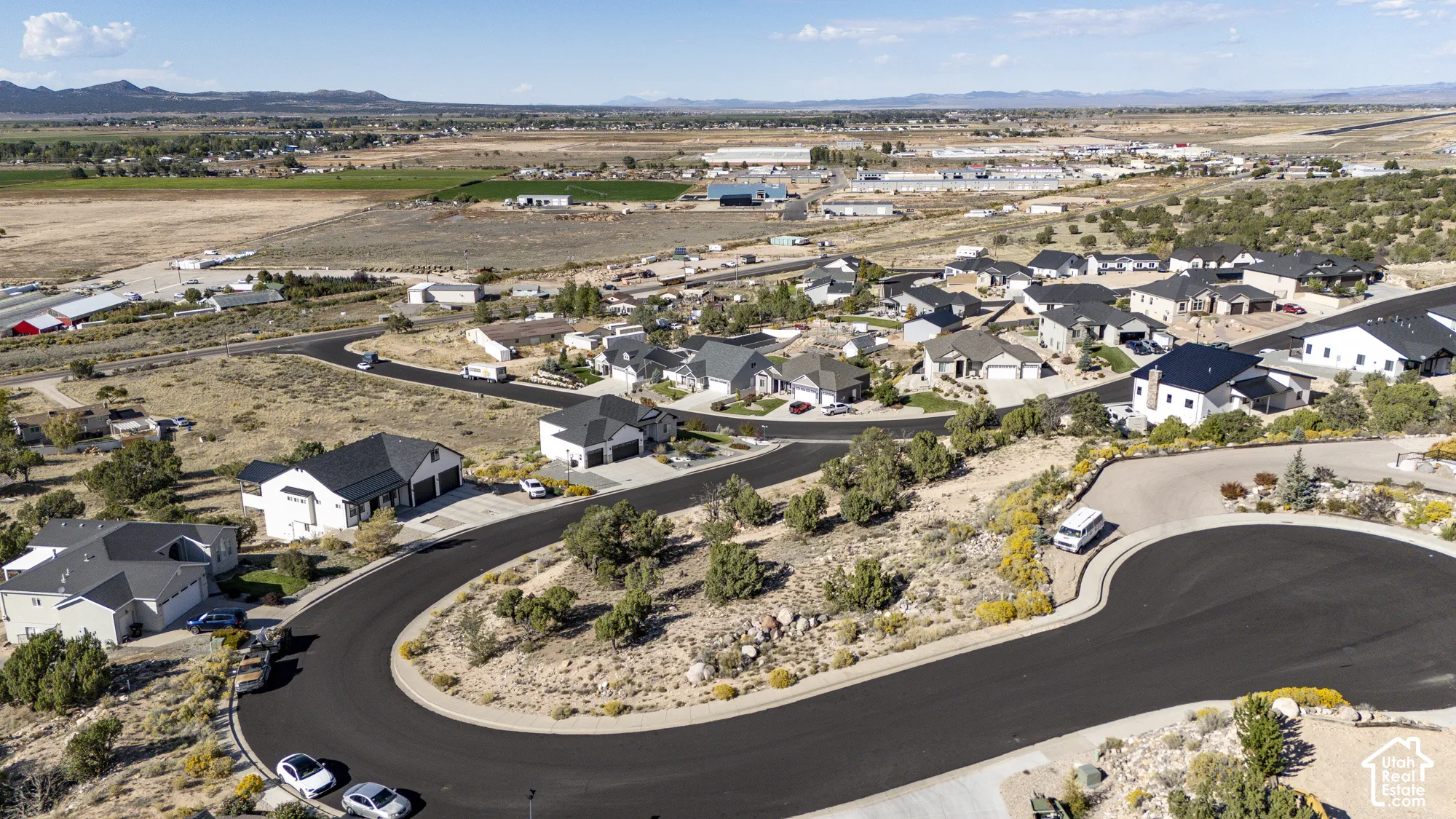 Residential development with paved roads and mature desert landscaping