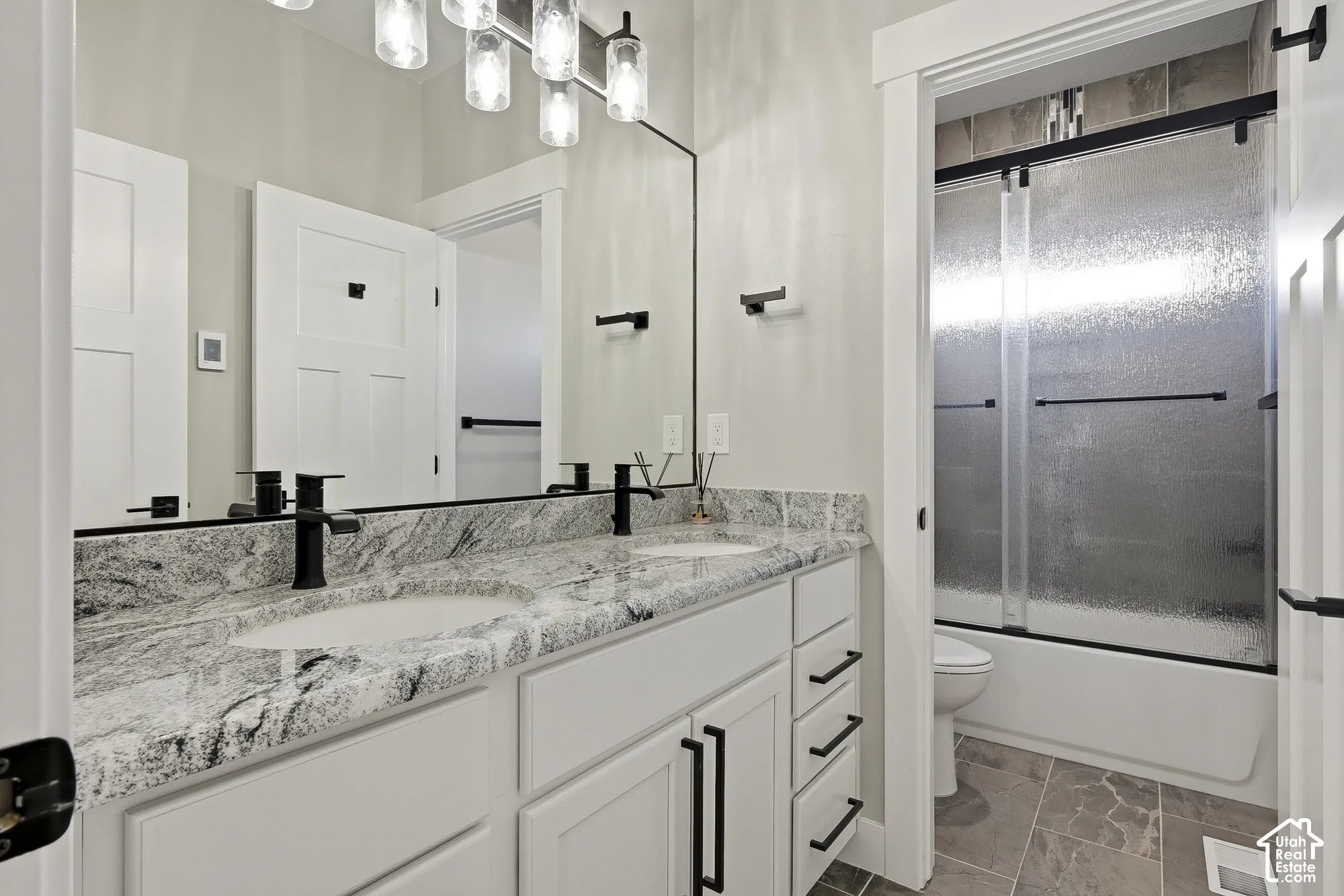 Dual vanity with integrated sinks and a stone-finish countertop