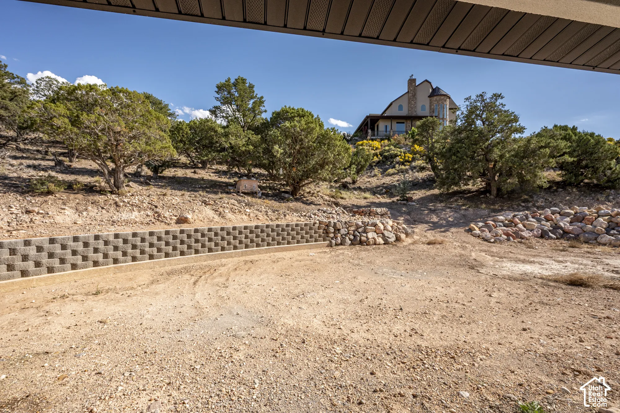 Stone-clad home with a prominent chimney and circular tower element