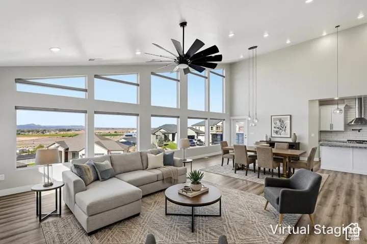 Great room featuring high ceilings, extensive window array, and wood-finish flooring