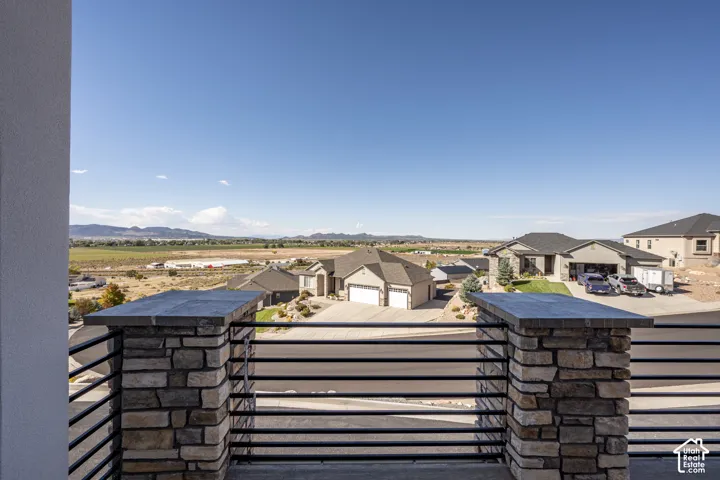 Stone-clad balcony pillars with horizontal metal railings