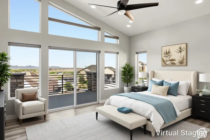 Vaulted ceiling with a contemporary ceiling fan, recessed lighting, expansive glass doors, multiple windows, and wood-finish flooring