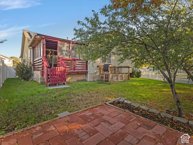 Screened deck with red wood railings and steps, featuring a glass sliding door