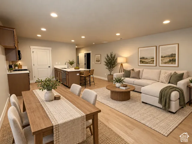 Open-concept living area with wood-finish flooring, recessed lighting, a kitchen island with seating, white countertops, and wood cabinetry