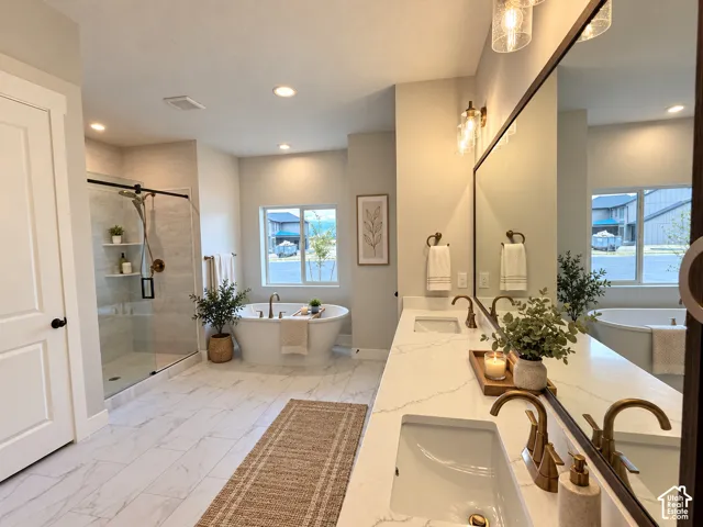 Dual vanity with undermount sinks and brass-finish fixtures