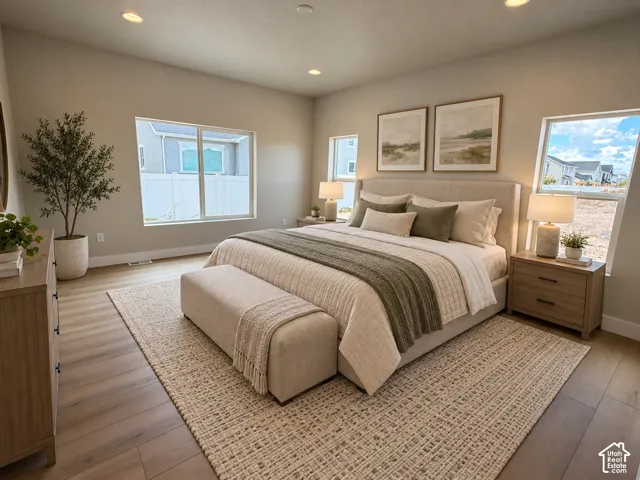 Vaulted ceilings, wood-finish flooring, recessed lighting, and expansive windows