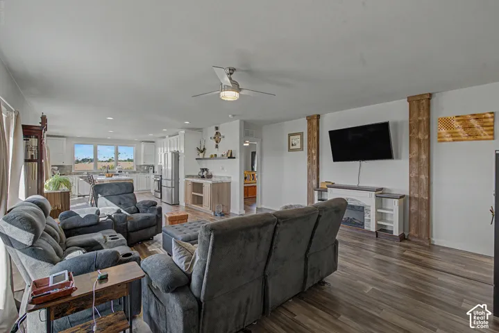 Spacious open-concept living area featuring wood-finish flooring, recessed lighting, and a ceiling fan