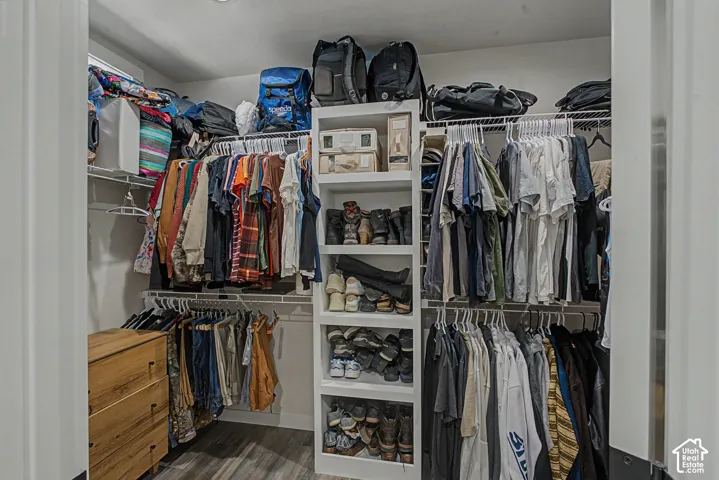 Custom closet system featuring tiered hanging rods and integrated shelving