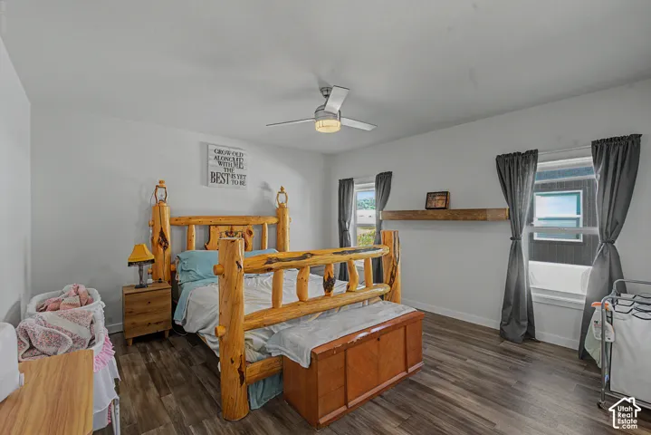 Wood-finish flooring throughout, bright white walls, and a ceiling fan with integrated lighting