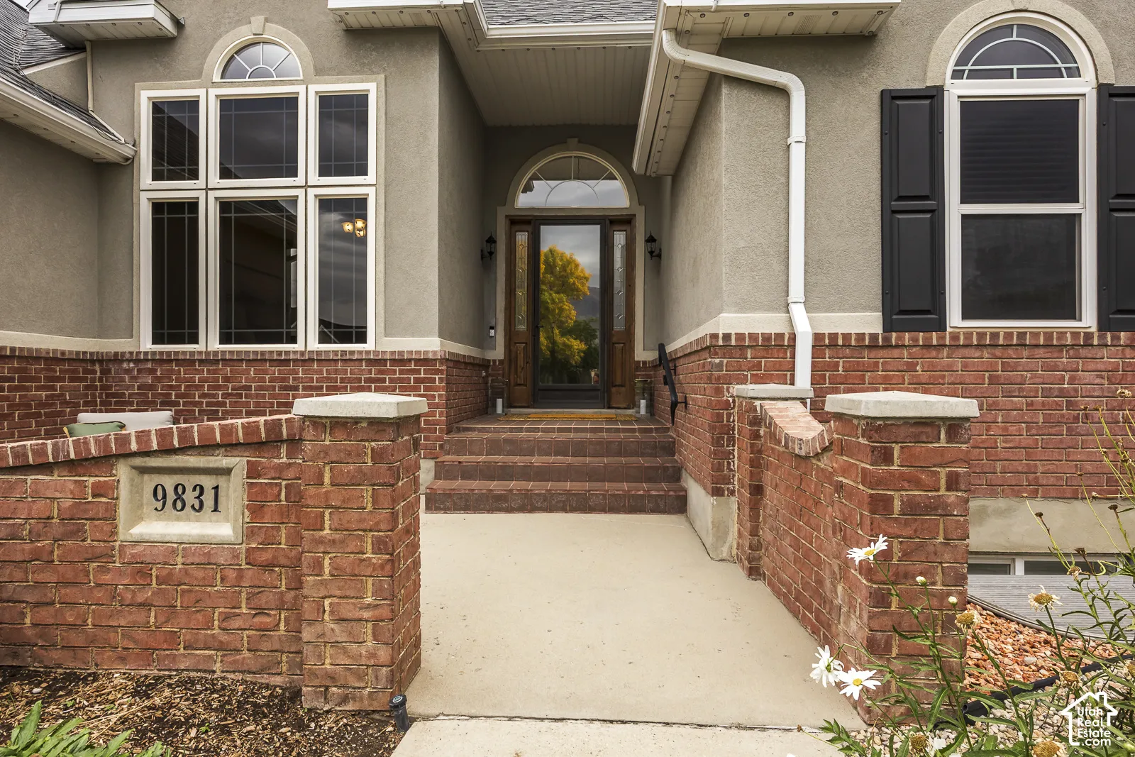 Stucco and brick exterior with arched entryway