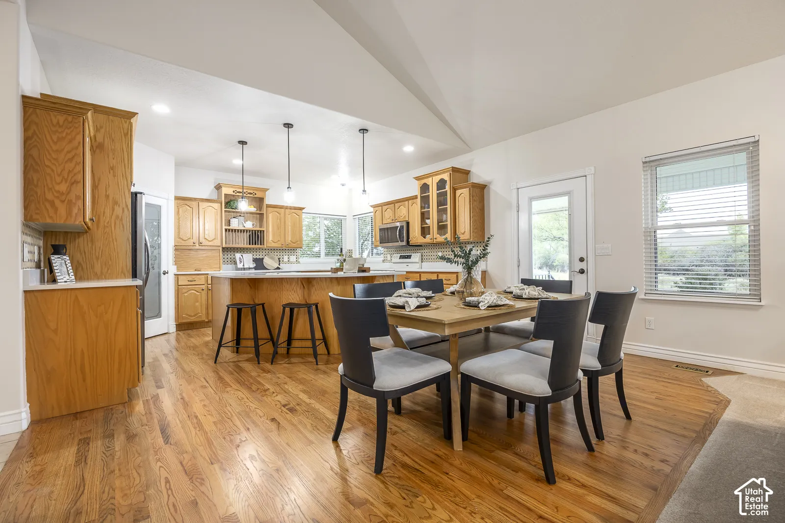 Wood-finish flooring throughout the main area, complemented by a vaulted ceiling