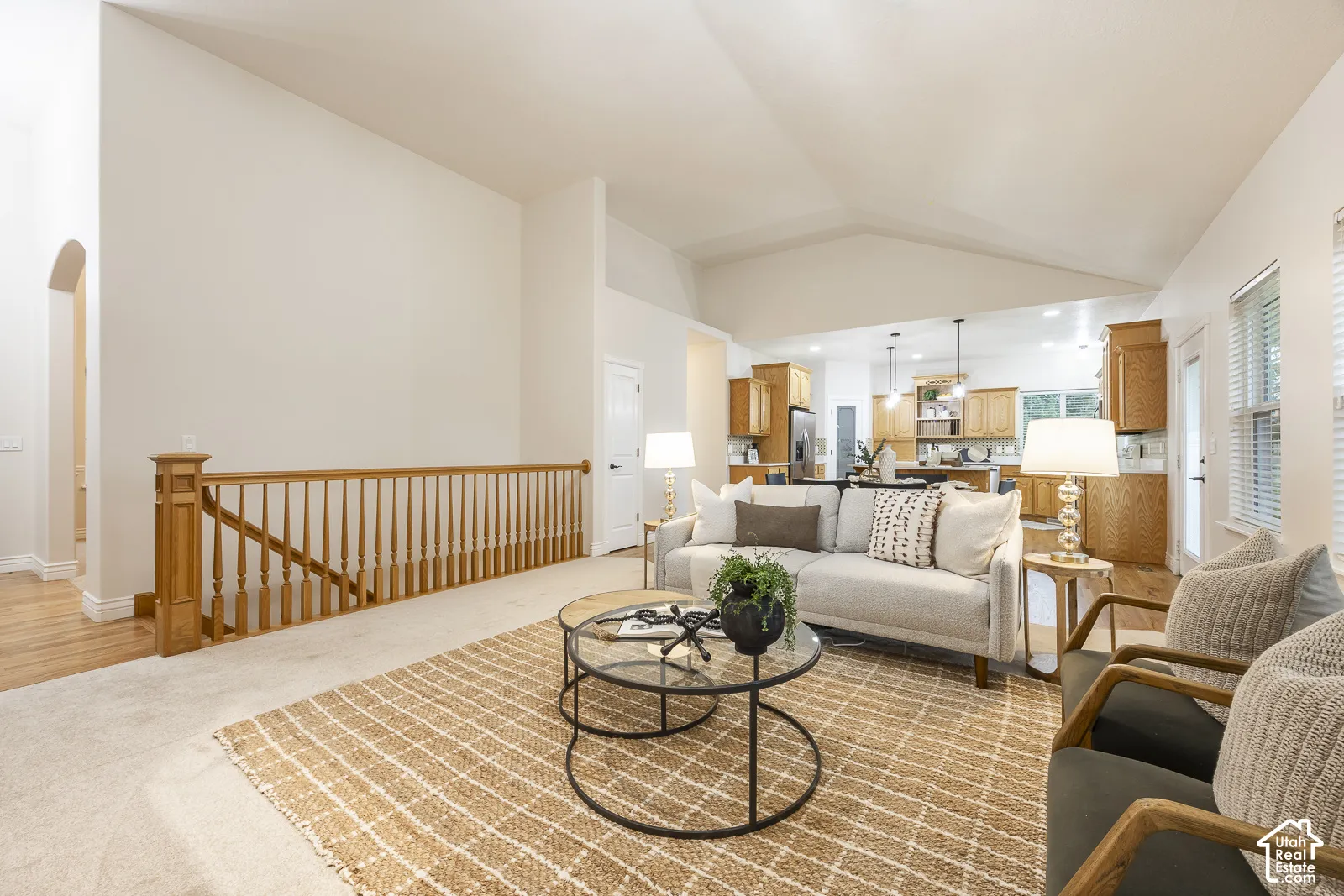 Vaulted ceilings, wood-finish flooring, and an open-concept layout