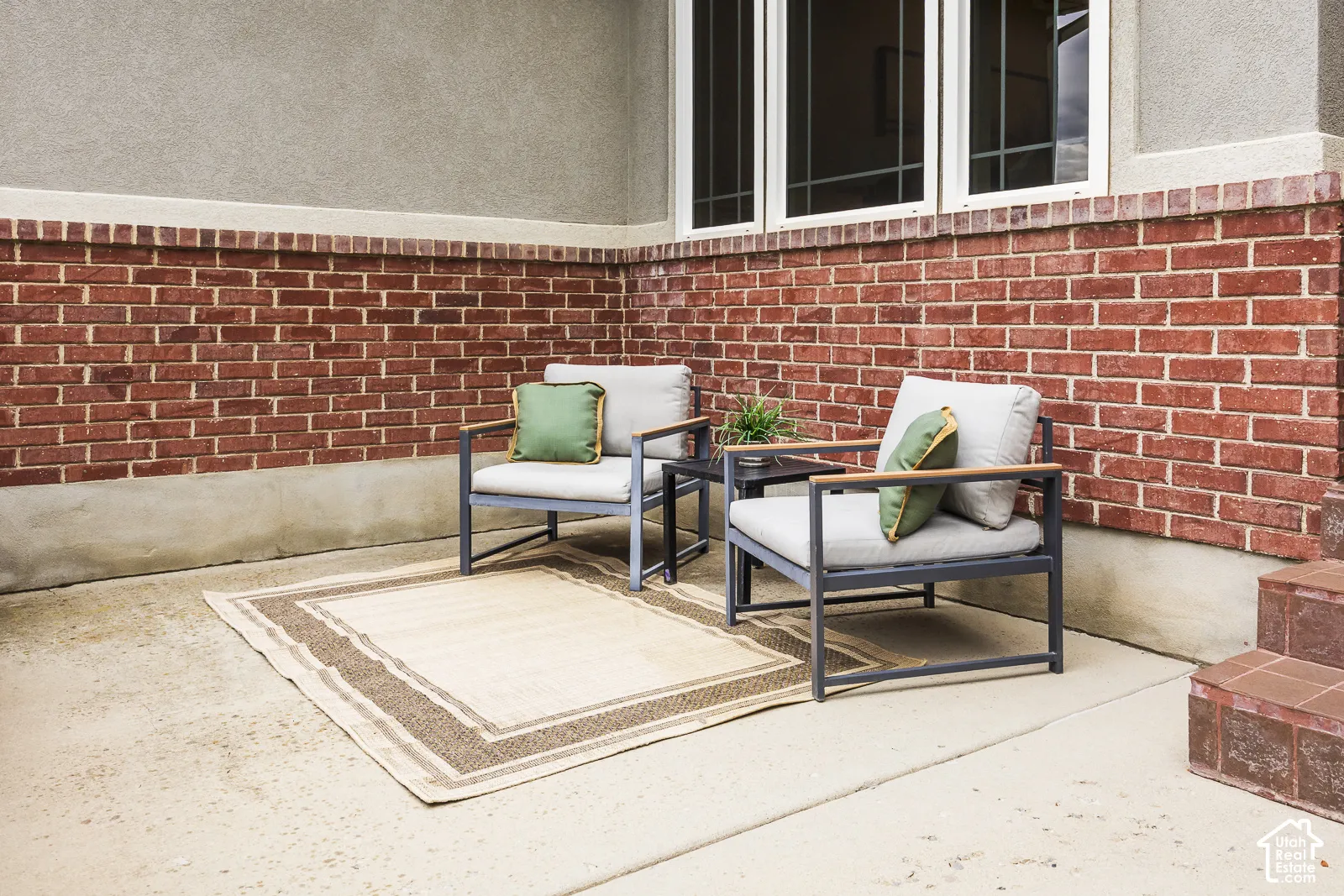 Concrete patio with brick and stucco exterior