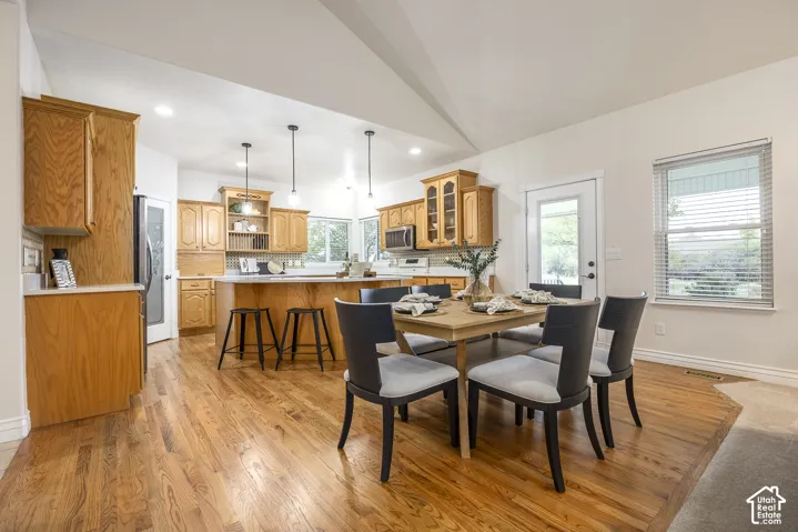 Wood-finish flooring throughout the main area, complemented by a vaulted ceiling