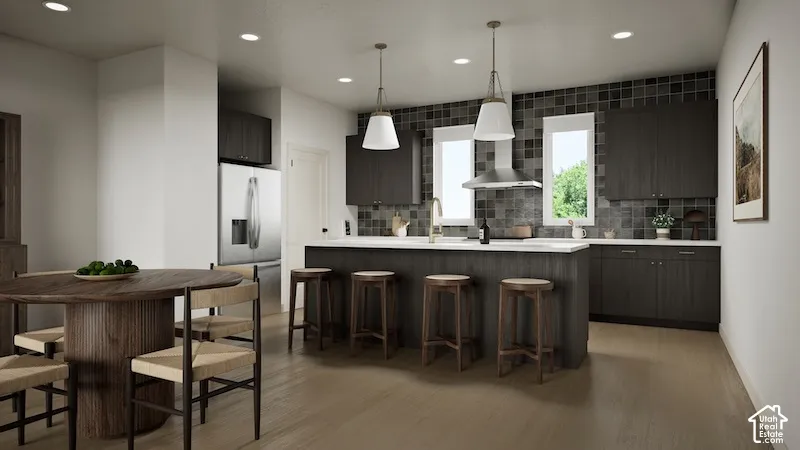 Open-concept kitchen featuring dark wood-finish cabinetry, a large kitchen island with seating, stainless steel appliances, a tile backsplash, and recessed lighting