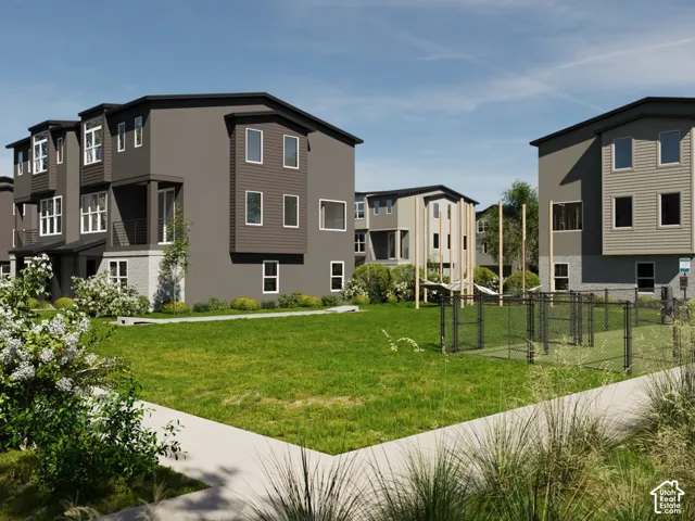 Modern townhome architecture featuring varied exterior siding, multiple windows, and a covered entry