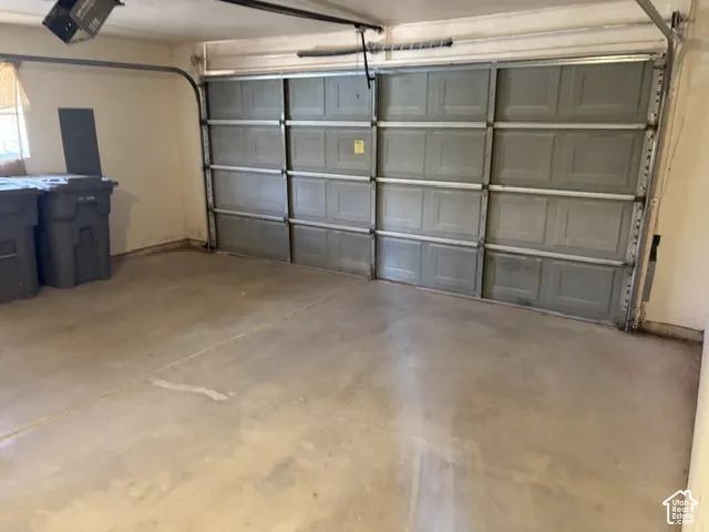 Attached garage with concrete flooring