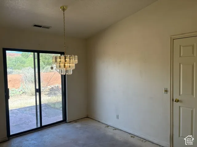 Sliding glass doors leading to a concrete patio from the semi-formal dining area