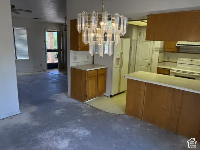 Kitchen to semi-formal dining area with a decorative chandelier
