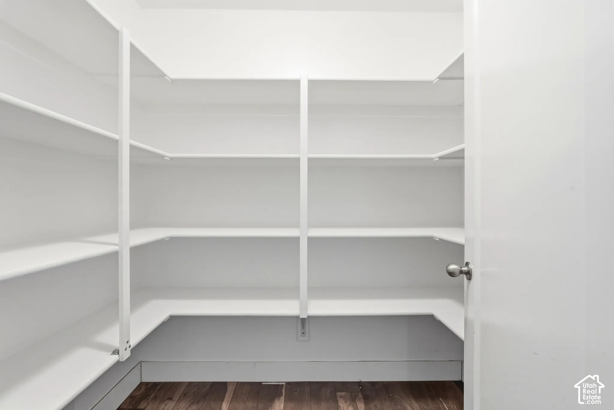 White shelving system with a wood-finish floor
