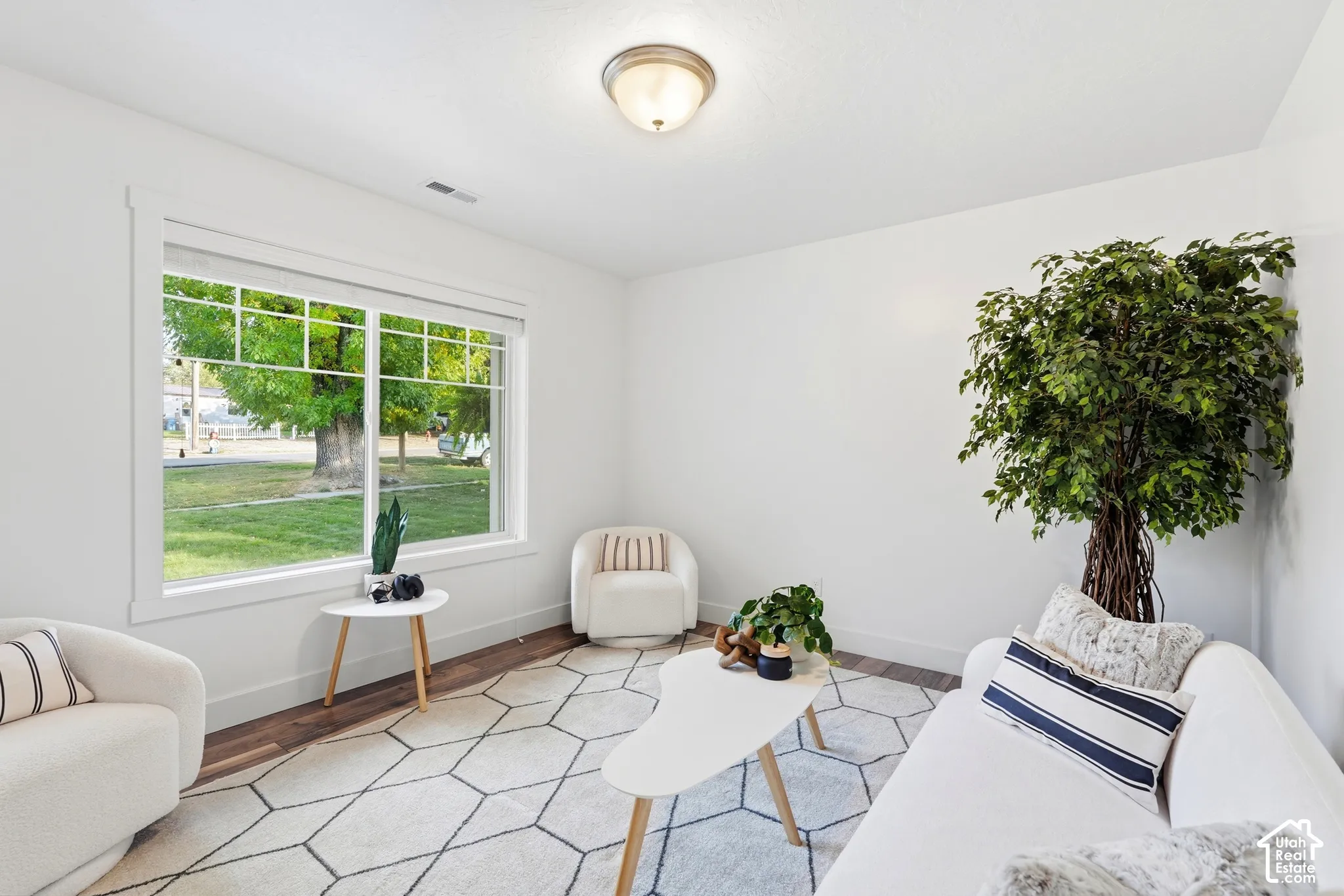 Large window with white trim, wood-finish flooring, and recessed lighting