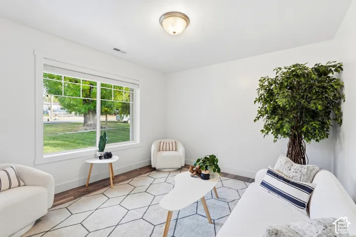 Large window with white trim, wood-finish flooring, and recessed lighting