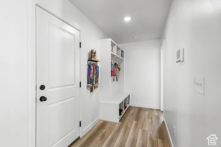 Built-in storage solutions, wood-finish flooring, recessed lighting, and a neutral color palette