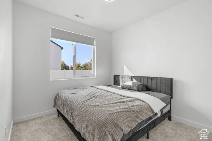 Recessed lighting, carpeted flooring, and a window with roller shade
