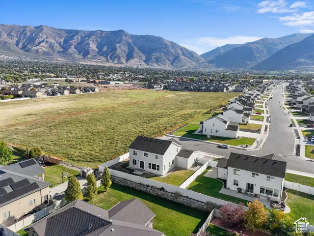 Expansive mountain scenery framing a residential neighborhood with paved streets