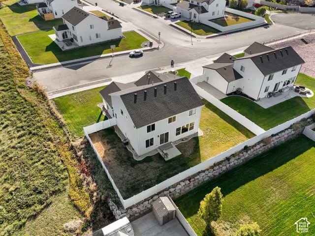 Two-story residence with a dark shingle roof, white exterior siding, and multiple windows
