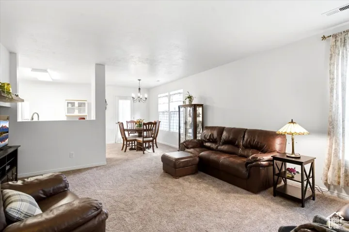 Recessed lighting, wood-finish flooring, half wall partition, chandelier