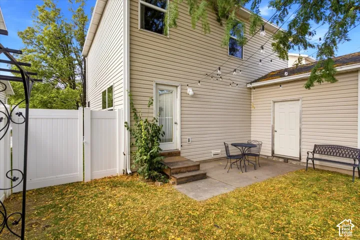 Open patio area with private fully fenced backyard