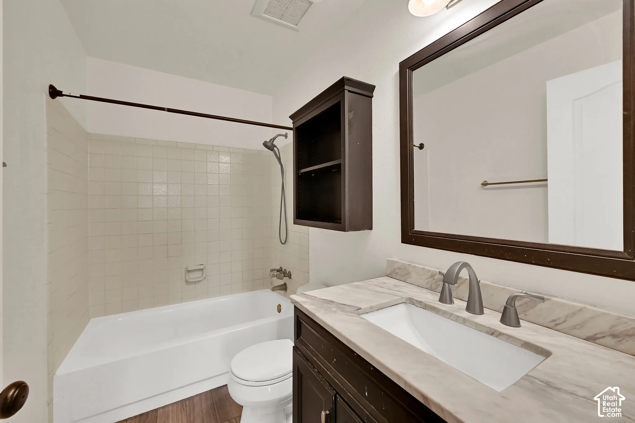 Vanity with a light-colored countertop and integrated sink