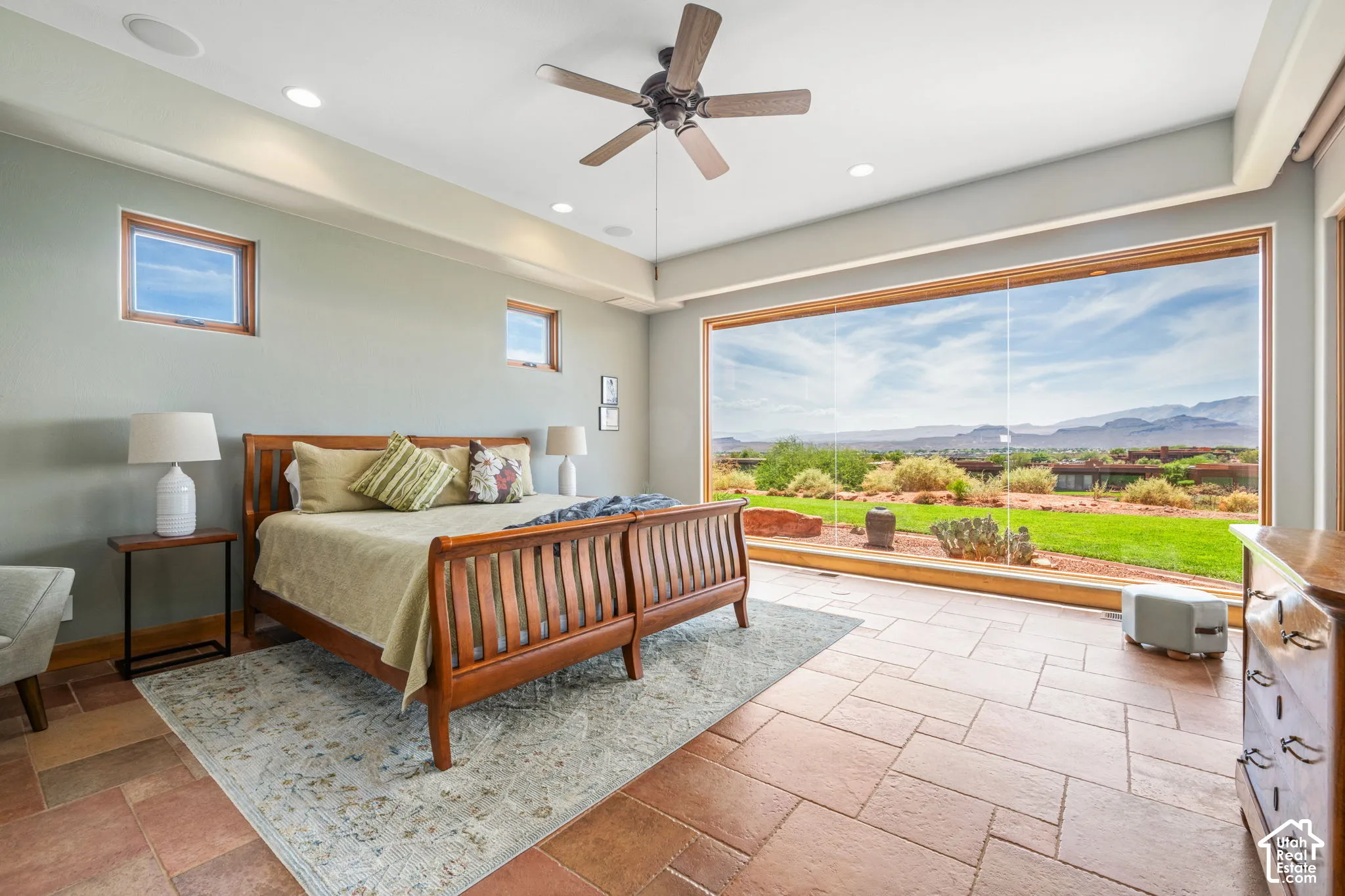Expansive picture window, recessed lighting, ceiling fan, and tile flooring