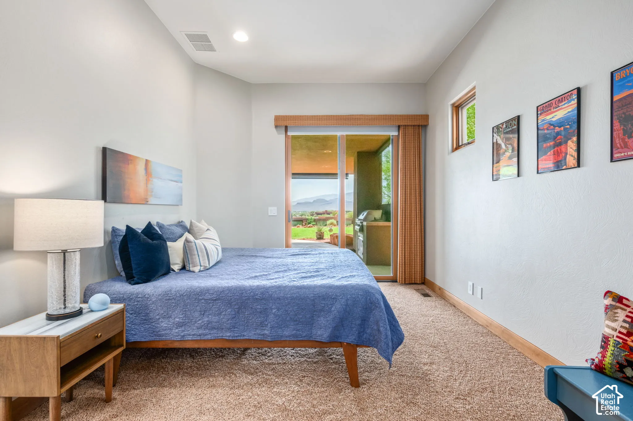 Carpeted room with a sliding glass door, recessed lighting, and a transom window