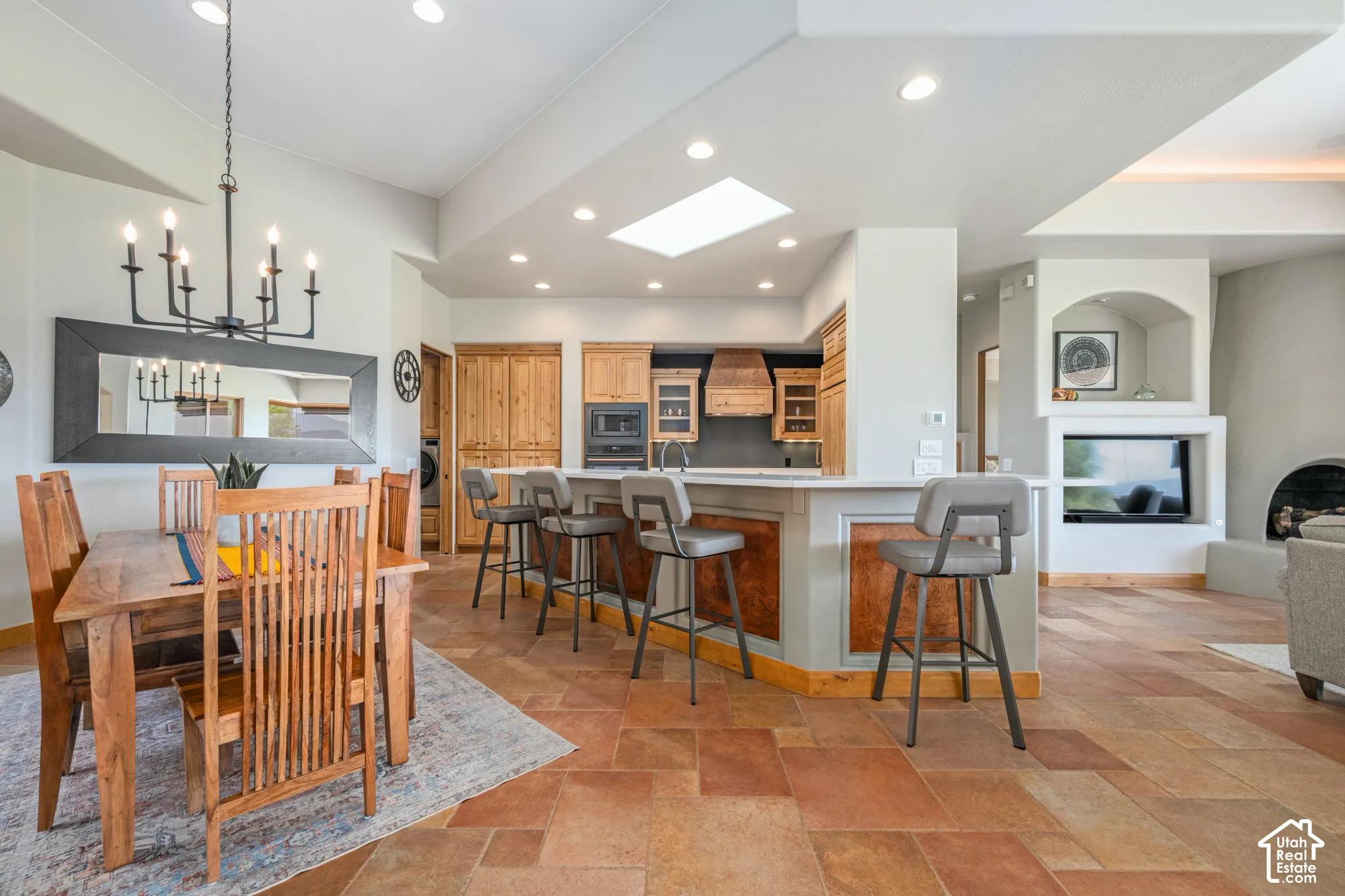 Kitchen featuring wood-finish cabinetry, built-in appliances, and a breakfast bar