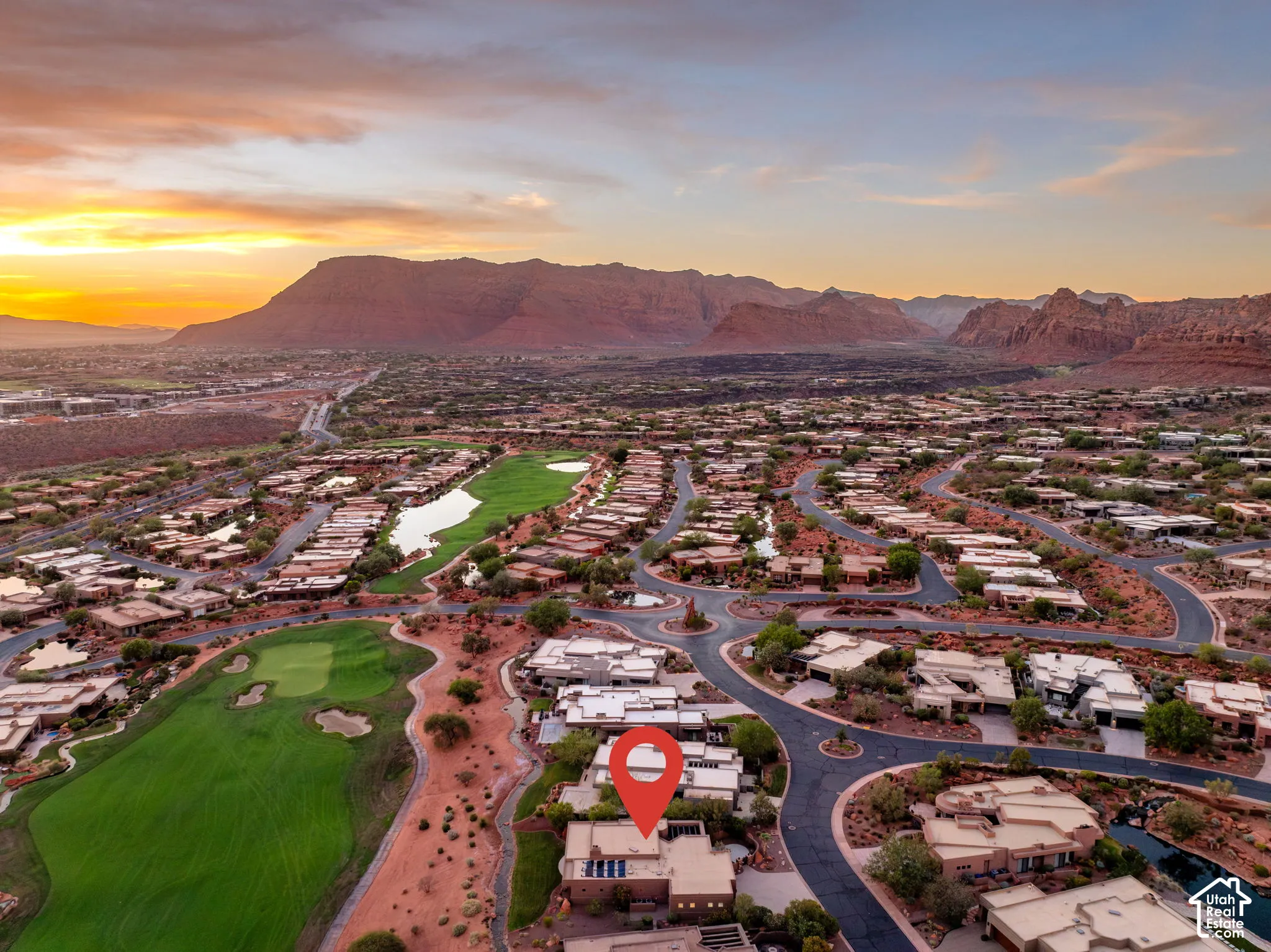 Aerial perspective showcasing a residential community with winding roads, golf course fairways, and natural desert landscaping