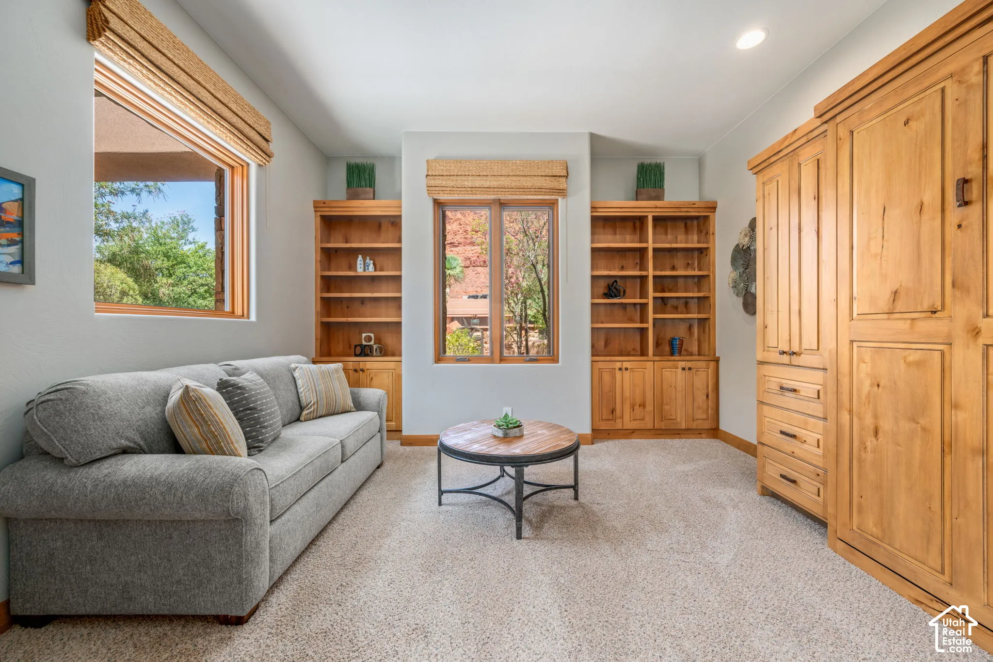 Built-in wooden shelving, a large built-in wooden cabinet, and recessed ceiling lighting
