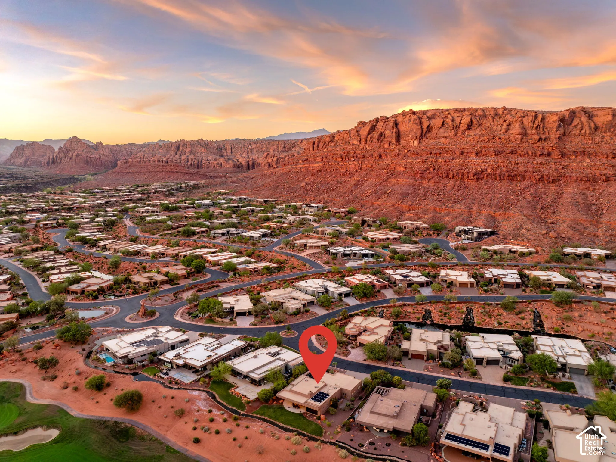 Residential property set against a dramatic rock formation backdrop